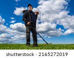 Small photo of Treasure hunter. Man with shovel and metal detector. Magnetic metal detector in hands of man. Search for lost treasures concept. Treasure hunter use metal detector. Sensor for finding iron or gold
