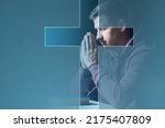 Small photo of Believing Christian. Man prays to God. Christian crucifix in front of praying man. Catholic guy with closed eyes. Christian in pose of prayer. Concept of study of Catholic religion. Appeal to God