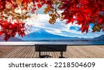 Small photo of Japan Fujiyama. Pier lake Kawaguchiko. Mount Fuji. Wooden bench for meditation. Mount Fuji with snow-capped peak. Autumn Japan. Red maple leaves in front of Mount Fuji. Nature of Japan
