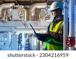 Small photo of Production engineer. Technologist with laptop. Man works in factory. Engineer near industrial equipment. Chemical production. Master maintains industrial equipment. Man jobs in chemical plant