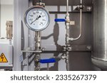 Small photo of Mechanical gas pressure sensor. Thin pipes with large gauge rounds. Arrow indicates absence of pressure in pipe. Energy equipment. Steel pipes near compressor station. Gas distribution technologies.