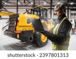 Small photo of Construction company employee. Man builder with laptop. Construction company engineer. Guy in hangar with bulldozer. Concept development software for construction equipment. Man in reflective vest