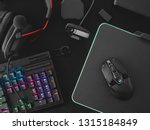 streaming games concept, top view a gaming gear, mouse, Webcams, keyboard, joystick, headset and mouse pad on black table background.