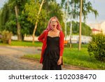 Small photo of yawns and ill-bred with open mouth young lady portrait in evening summer outdoor park environment concept