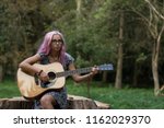 Small photo of discomfit confuse young beautiful girl portrait in learning play acoustic guitar time on outdoor park natural background environment