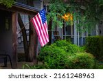 Small photo of An American flag hangs in a neighborhood of the King William Historic District in San Antonio, Texas.
