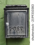 Small photo of Old metal mailbox on a green wall. Retry style.