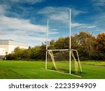 Small photo of Small size tall goal post for training rugby, camogie, hurling, Gaelic football. Pitch for Irish National sport practice. Warm sunny day, Blue cloudy sky. Sport equipment in a field.