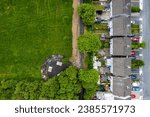 Small photo of Aerial view on high density living area with houses built close to each other and park. Residential area in Ireland with private housing. City planning and developing concept.