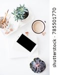 Small photo of office desk flat lay with coffe, smartphone and succulents, clea