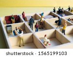 Small photo of Miniature people separated in office cubicles.Work in a sterile office environment. People divided in little boxes. Personal space to complete your work. Office politics, romance, or drama.