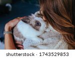 Girl Hugs A Cute White Rabbit...