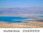 Stunning view of salt deposits and turquoise water of the Dead Sea and Judean Desert in Israel with Jordan mountains in background