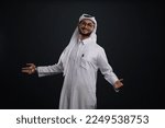Small photo of Doha, Qatar - January 14, 2023: Qatari Man using tab posing in studio various expression.
