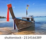 Small photo of Beautiful local boat service for traveller. Translation: "Boat has been painted with Thai words mean Nim (people name) and also the maximum allowed weight for carrying with Boat register number.