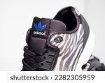 Small photo of kent, uk 01.01.2023 RARE ADIDAS torsion zx FLUX DECON zebra print basketball and sport trainers , stylish retro football street fashion. famous 3 stripes torsion trademark. famous three stripes brand