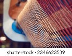 Small photo of Cootn threads in industrial cotton in a weaving factory, machine weaving cotton for the fashion and textiles industry. Yarn weave traditional textile fabric manufacturing for clothing and fashion