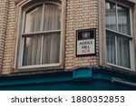 Small photo of London, UK - November 19, 2020: Low angle view of a street name sign on a building in Addle Hill in the City of London, London's famous financial district.