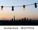 Small photo of LONDON, UK - AUGUST 30, 2016: View of London skyline silhouette from an outdoor cinema party at Bussey Building Rooftop, Peckham, during sunset.