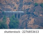 Small photo of The Solapur to Mumbai Vande Bharat Express travels down hill on the Bhor Ghats at Monkey Hill near Khandala.