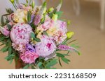 Rich bunch of pink peonies and lilac eustoma roses flowers, green leaf . Fresh spring bouquet. Holodays, gift.Arrangement of Beautiful blossoming flowers.wedding bouquet.copy space