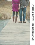 Man And Woman Standing On Dock...