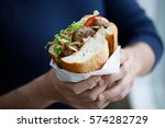 Half bread meatball sandwich on the hands on a man (Turkish street food)