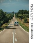 Small photo of Straight long road with lonely car through rural landscape and leafy trees, on sunny day near Castelo Branco. Friendly and important city, it was a former bishopric in the central region of Portugal.