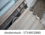 Small photo of Cement roof sheets are lain down on the floor.