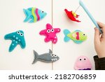 Small photo of Hand made stuffed felt toy. Fishing rod with magnet and fishes or other sea animals. Different colors. Safe eco stuffed toy for infants and toddlers. Early education implement.