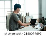 Small photo of Young Man Asian LGBTQ Tailor Shop Owner,The typist chats with the customer about cutting the dress, with a happy face,Small business Professional Design clothes to sell online.
