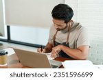 Small photo of Asian male cafe owner sitting in cafe, man had very serious expression, due tearing down shop account make retrospective profit check, it was found that profit had disappeared from original.