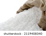 Small photo of Mineral nitrogen fertilizer urea. Urea granules in a bag. Ammonium nitrate in a sack on a white background.