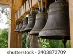 Small photo of Church bells hang in a row, the bells are ringing. Church bell, several church bells in the monastery. Several metal church bells, bell ringing.