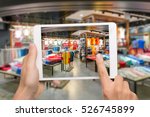 Augmented reality marketing concept. Hand holding digital tablet smart phone use AR application to check special sale price in retail fashion shop mall