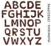 Small photo of English alphabet of freshly roasted cocoa beans on a white isolated background. coffee pattern made from coffee beans. Font for coffein, the concept of vivacity and culture of coffee. Writing Letters