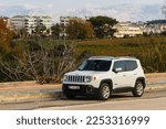 Small photo of Side, Turkey -January 21, 2023: white Jeep Renegade is parking on the street on a summer day against the backdrop of a city