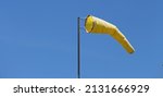Yellow Windsock On A Pole With...