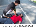Small photo of Men are doing first aid by Cardiopulmonary Resuscitation or CPR to friends with sudden cardiac arrest. During exercise together Within the park