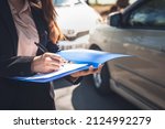 Small photo of Woman notify insurance agents is writing an accident car crash report, to people and transportation insurance concept.