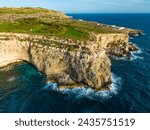 Small photo of Aerial drone view of greeny cliffs and hills of Maltese island, nature landscape. Mediterranean sea