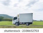 Small photo of Side view of a small truck driving on a country road, truck running on the road, small truck on the road.