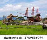 Small photo of Pattalung, TH - MARCH 19, 2020: Scenery of the local rice farm in Samphao Thai park, one of attraction in Pattalung that can see a giant king kong and Chinese argosy ship made from straw, as landmark.