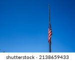 Small photo of LOS ANGELES, CA - October 19, 2021: A U.S. flag at half-mast in honor of Colin Powell, former secretary of state.
