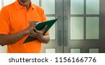 Small photo of Delivery man chek list item on note scrip.