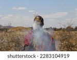 Small photo of Keeping Traditions Alive: Maasai Mara Tribesman Ignites a Fire in His Village, Kenya