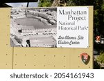 Small photo of Manhattan Project National Historical Park sign at Los Alamos Site visitor center - Los Alamos, New Mexico, USA - 2021