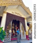 Small photo of Penang Malaysia - February 22 2023: Tourist at Dharmikarama Burmese Temple in Georgetown Penang, Malaysia Burmese temple of Myanmar, Penang, Malaysia