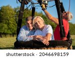 Adventure love couple on hot air balloon. Man and woman love each other. Burner directing flame into. Preparing for the flight. instructor