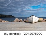 A White Wooden Fishing Boat On...